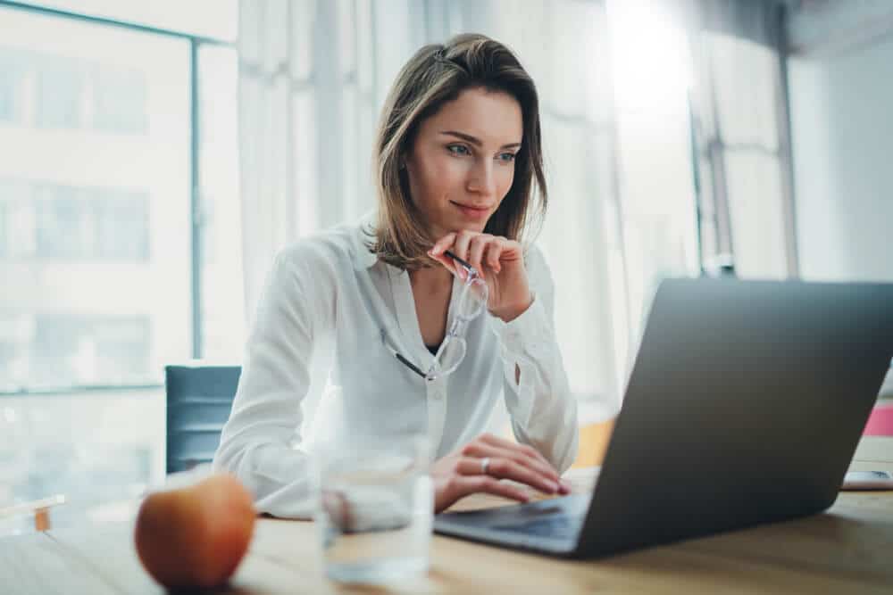 Smiling female professional working on laptop